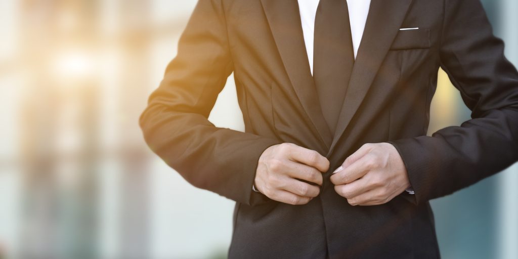 close up of businessman in black suit tying the ne 2022 10 26 04 52 44 utc
